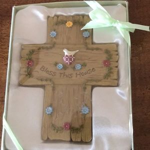 Very pretty wooded cross with pretty flowers and a bird .